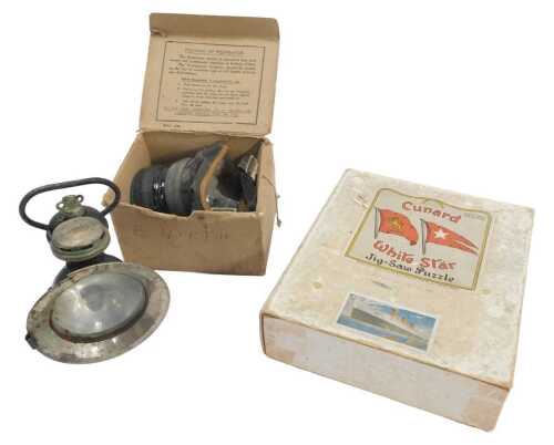A Cunard White Star wooden jigsaw puzzle, boxed, together with a gas mask in a cardboard box,...