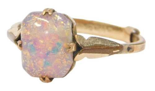 A single stone dress ring, set with imitation opal, on a rolled gold band, with ring sizer, ring...