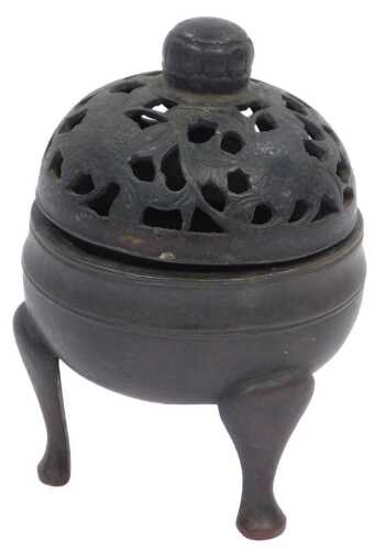 A Chinese Qing Dynasty bronze tripod censer, of plain design with pierced flower head and scroll...