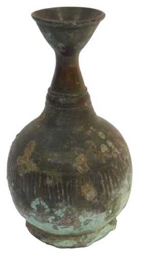 An archaic bronze bottle vase, possibly Korean, with flared neck and ribbed body, raised on a...