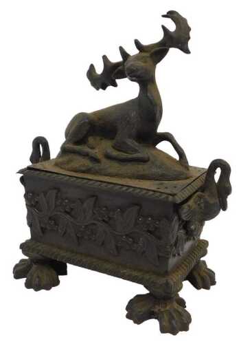 An 18thC Continental cast bronze ink stand, the lid surmounted with a recumbent deer, the casket...
