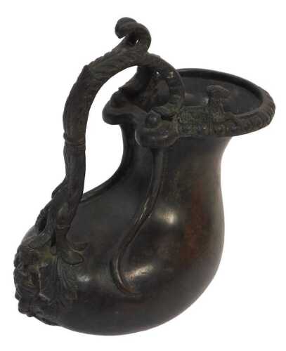 An 18thC bronze water vessel, of lobed design, with scrolling handle and cherub terminal, two...