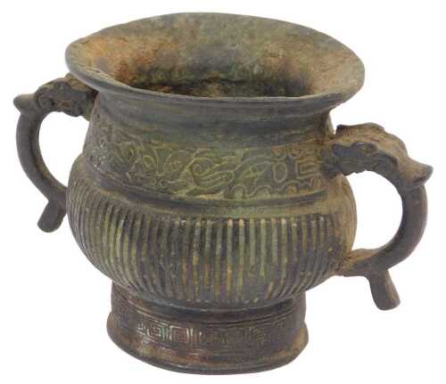 A Chinese Qing dynasty two-handled vessel, with flared border and two stylised dragon handles,...