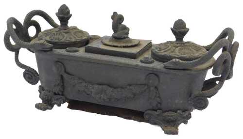 A 19thC Grand Tour bronze double inkwell, with serpentine handles, shell pattern covers with...