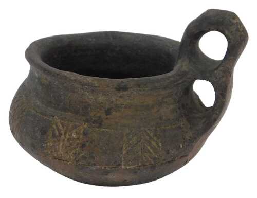 An archaic pottery ring handled cup, possibly South American, with a double ring handle and...