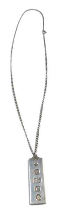 A silver ingot pendant and chain, the ingot 1977, 4cm high, on fine link chain, 50cm long, 22.2g.