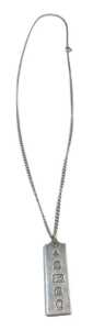 A silver ingot pendant and chain, the ingot 1977, 4cm high, on fine link chain, 50cm long, 22.2g.