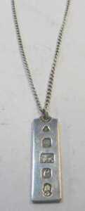 A silver ingot pendant and chain, the ingot 1977, 4cm high, on fine link chain, 50cm long, 22.2g. - 2