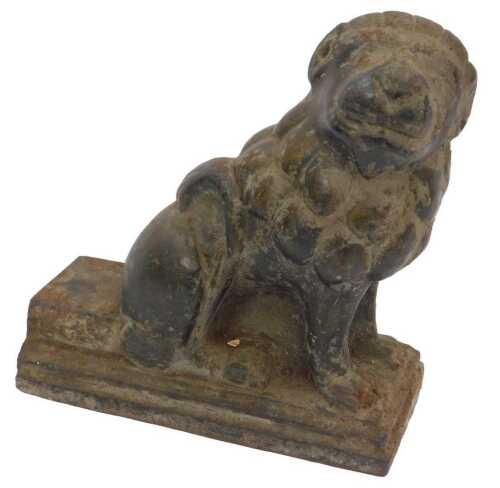 An 18thC Chinese patinated iron figure of a seated Temple Lion, 21cm high, 20.5cm long.