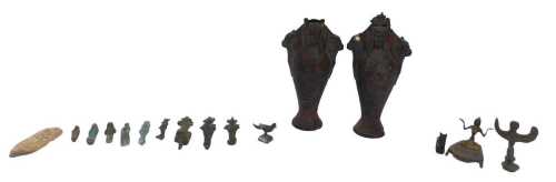 A collection of ancient Egyptian bronze statuary, including figures of the god Osiris, and later...