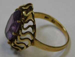 An amethyst dress ring, the oval cut amethyst in a six claw raised basket setting, with S design... - 3