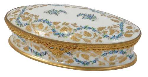 A 20thC French porcelain oval dressing table box and cover, decorated in raised gilt and enamels,...