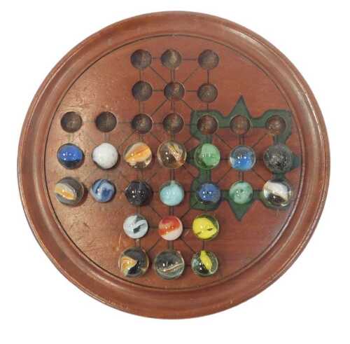 An early 20thC painted mahogany solitaire board, and a quantity of marbles, 22cm diameter.