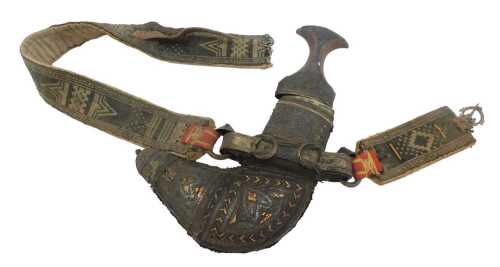 A Middle Eastern Khanjar ceremonial dagger, the curved blade within a woven and embossed metal...