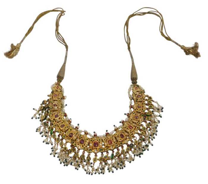 An antique enamel and gem set bridal necklace, the front set with an arrangement of green, red...