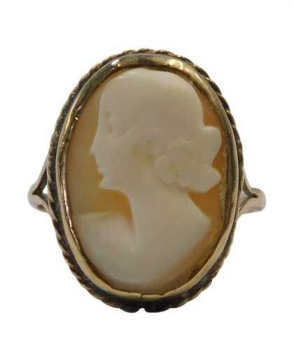 A shell cameo dress ring, quarter profile female facing sinister, in a rub over and pleated...