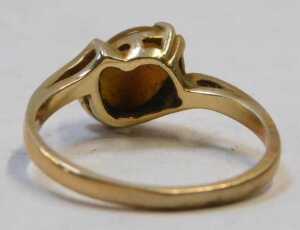 A tiger's eye dress ring, the oval-cut cabochon stone, in a four-claw mount setting, on a twist... - 3