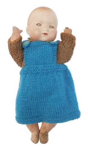 An Armand Marseilles porcelain and composition doll, wearing later knitted clothing, impressed...