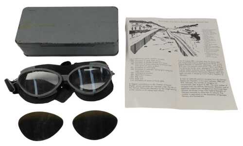 A pair of flying goggles, with grey painted rims, a pair of extra dark tinted lenses, etc.