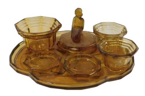 A 1920s amber tinted glass dressing table set, decorated in relief with female figures, etc.,...