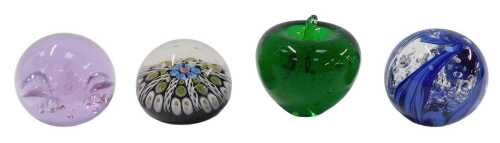 A Millefiori glass paperweight, with coloured canes, 7cm diameter, and three other paperweights....