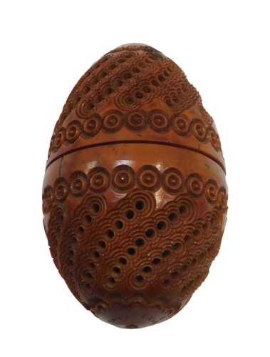 A 19thC carved egg shaped coquilla nut, with pierced roundel design, with a central screw...