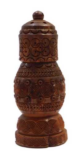 A carved coquilla nut pounce pot, decorated with repeat roundel motifs, 11.5cm high. (AF)
