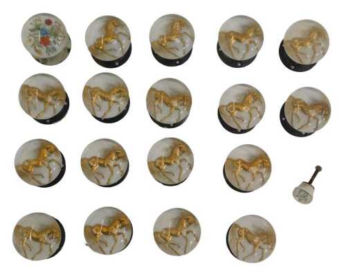 Seventeen Art Deco lucite doorknobs, each decorated internally with a horse in gilt, 7cm...