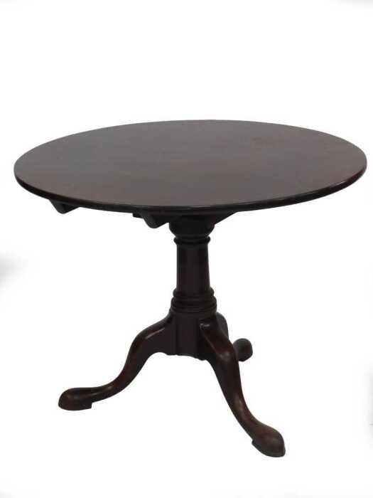 A George II mahogany supper table, with single piece circular tilt top, swivelling on a bird...