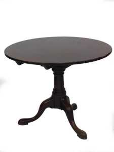 A George II mahogany supper table, with single piece circular tilt top, swivelling on a bird...
