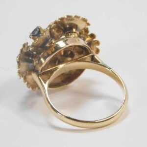 A 20thC floral cluster ring, formed as seven floral sections, on a frame, each with a round... - 2