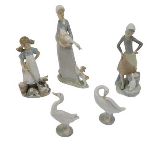 A group of Lladro porcelain, comprising three figures, the largest 32cm high, and two geese. (5)