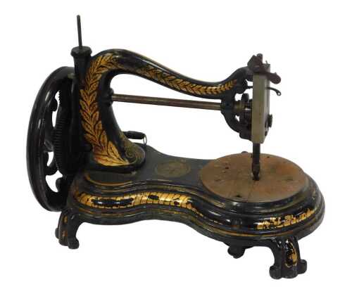 A Jones hand operated sewing machine, with partial gilt decoration, 35cm wide.