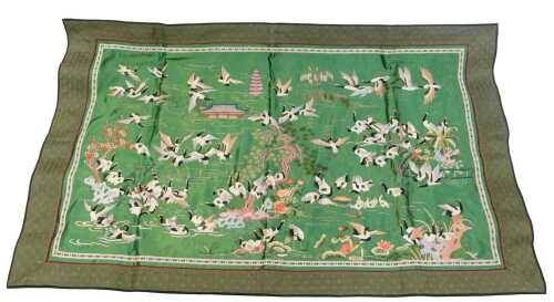 A 20thC Chinese embroidered silk panel, decorated with cranes and building against a green silk...