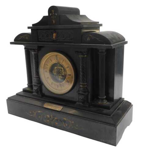A late Victorian black slate mantel clock, the brass dial bearing Roman numerals, with an eight...