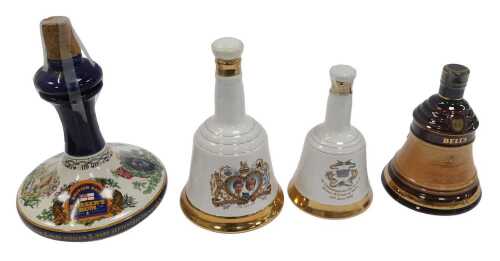 A British Navy Prusser's rum decanter, together with two Bell's whisky decanters, all with...