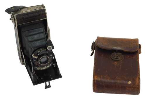 A Voigtlander folding camera, in a leather case.