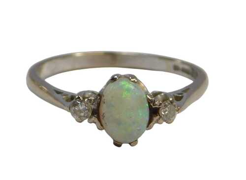 An 18ct white gold opal and diamond three-stone ring, in a claw setting, size O, 2.7g all in.