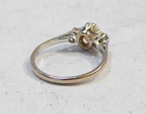 An 18ct white gold opal and diamond three-stone ring, in a claw setting, size O, 2.7g all in. - 2