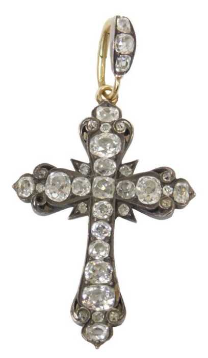 A diamond crucifix pendant, set with varying sized old mine cut diamonds, the largest end four...