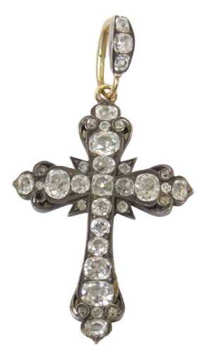 A diamond crucifix pendant, set with varying sized old mine cut diamonds, the largest end four...