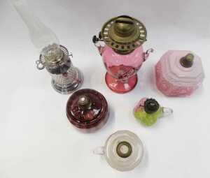 A group of Victorian and later oil lamp bases, central reservoirs, etc., to include a cranberry... - 2