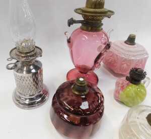 A group of Victorian and later oil lamp bases, central reservoirs, etc., to include a cranberry... - 3