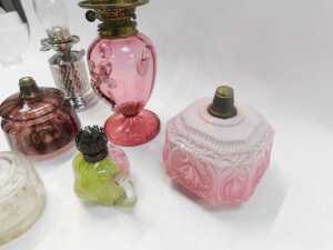A group of Victorian and later oil lamp bases, central reservoirs, etc., to include a cranberry... - 4