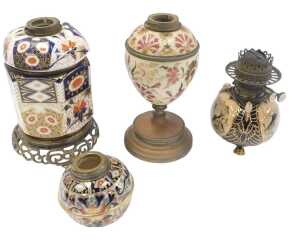 A group of oil lamp bases, to include a Zsolnay style pottery base, decorated with flowers, in...
