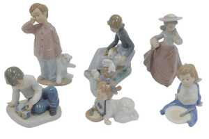 A group of Nao porcelain figures, to include a girl seated on a fallen tree trunk beside rabbits,...