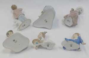 A group of Nao porcelain figures, to include a girl seated on a fallen tree trunk beside rabbits,... - 3