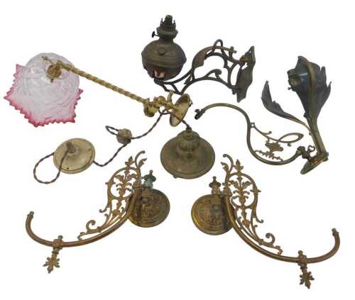 A group of brass and other oil lamp brackets, to include a brass example with a spirally turned...