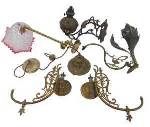 A group of brass and other oil lamp brackets, to include a brass example with a spirally turned...