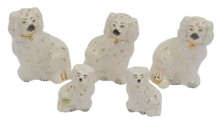 A group of Beswick Staffordshire style pottery spaniels, comprising three 15cm high, and two 9cm...